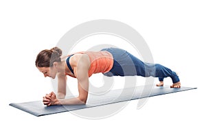 Woman doing Yoga asana Chaturanga dandasana plank pose photo