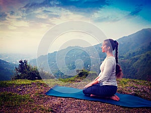 Woman doing Yoga asana Virasana Hero pose