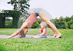 Woman doing yoga with baby in nature