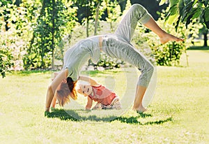 Woman doing yoga with baby in nature