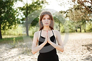 Woman doing yoga on the beach