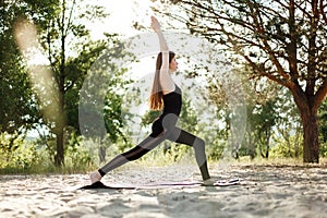 Woman doing yoga on the beach