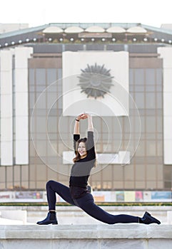 Woman doing yoga in city