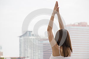 Woman is doing yoga in the city