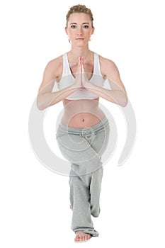 Woman doing yoga, eagle / garudasana position