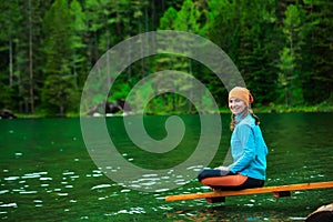 Woman is doing yoga excercises in Altai mountains