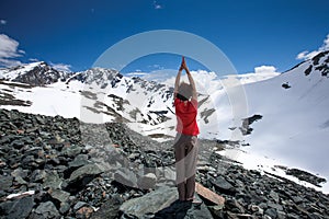 Woman is doing yoga excercises in Altai mountains