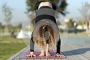 Woman doing yoga exercise away from city life