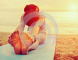 Woman doing yoga exercise on beach