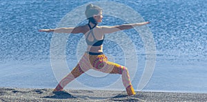 Woman doing yoga exercise on the beach, woman relaxing on the beach, woman doing yoga