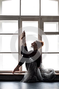 Woman doing yoga exercise called Both Big Toes or Ubhaya Padangusthasana