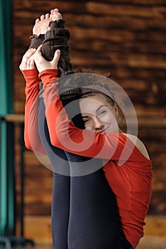 Woman doing yoga exercise called Both Big Toes or Ubhaya Padangusthasana photo