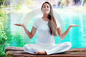 Woman doing yoga exercise at lake.