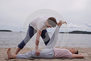 Woman doing yoga exercise lying in Supta Padangushthasana