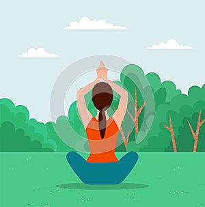 Woman doing yoga exercise. Young fit girl sitting in lotus position on the grass in city park