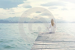 Woman doing yoga exercises in front of a spectacular scenery