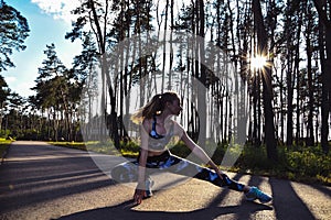 Woman Doing Yoga in forest Against Sky and Sun. Hard light. Silhouette of girl doing outdoor sport stretch