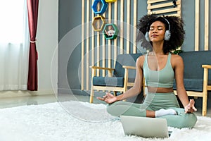 Woman doing yoga at home in the living room. Woman is stretching in yoga at home. work out time