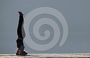 Woman doing yoga by the lake