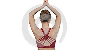 Woman doing yoga lotus pose with hands coupled on white background.