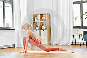 Woman doing yoga and low lunge exercise at home