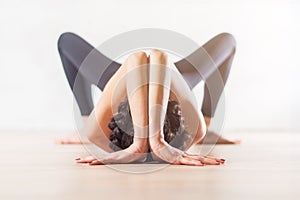 Woman doing yoga lying on floor in artistic aesthetical posture. photo
