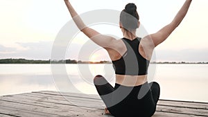 Woman doing yoga namaste, meditation sitting in lotus position, enjoy body relax