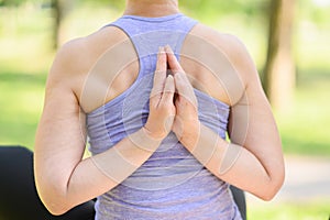 Woman doing yoga in nature doing reverse prayer, namaste behind her back.The concept of stretching, yoga.