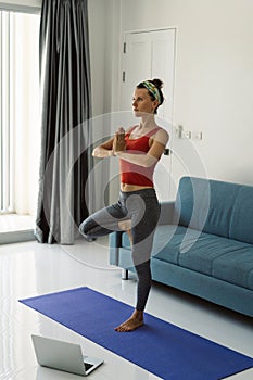 Woman doing yoga online