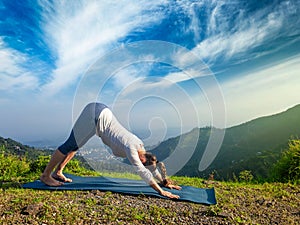 Woman doing yoga oudoors in mountains