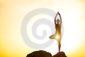 Woman Doing Yoga Outdoor. Warm up Exercise Against Sunset. Sport and Healthy Active Lifesyle Concept.