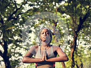 A woman doing yoga in the park