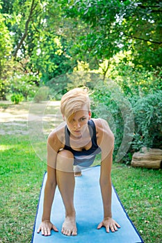Woman doing yoga in the park, the concept of a healthy lifestyle