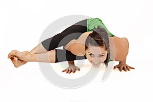 Woman doing yoga pose called eight angle pose