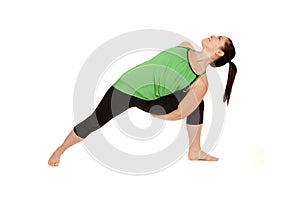 Woman doing yoga pose called revolved extended sid