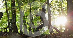 Woman doing yoga pose in the forest