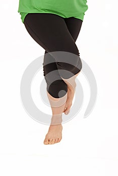 Woman doing yoga pose legs in eagle Garudasana Pos