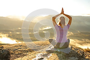 Woman doing yoga pose in the mountain