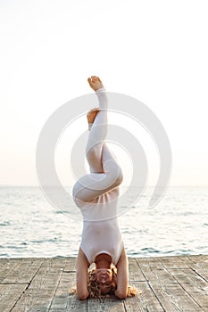 Woman Doing Yoga By The Sea