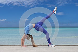 Woman doing yoga by the sea