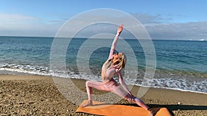 Woman doing yoga by the sea