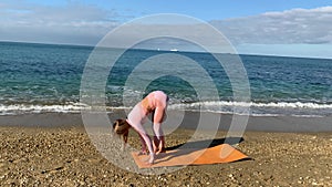 Woman doing yoga by the sea