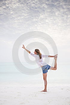 woman doing yoga by the sea pastel colors