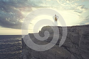 Woman doing yoga seeks inner balance in front of the ocean