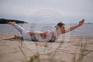 Woman doing yoga shalabhasana or locust pose