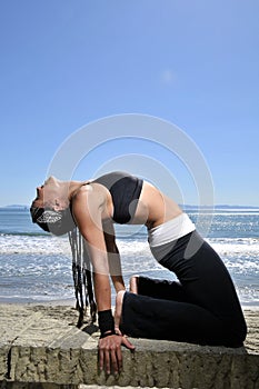 Woman doing yoga stretch on beach