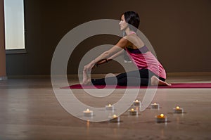 Woman doing yoga stretches at home on yoga mat