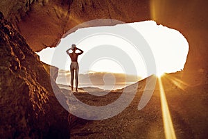 Woman doing yoga, stretching, meditating on the top of a mountain