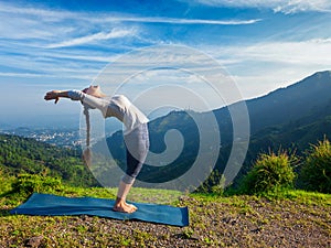 Woman doing yoga Sun Salutation Surya Namaskar