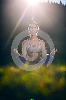 Woman doing yoga in sunset